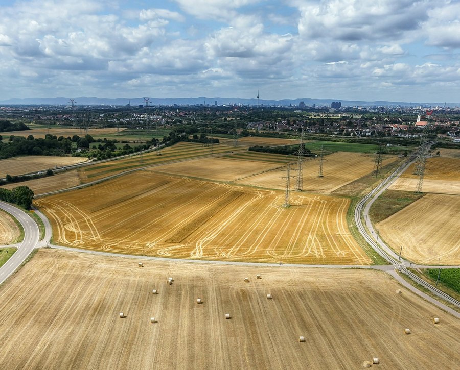 Aerial view of subdivided farmland and roads on the edge of a city