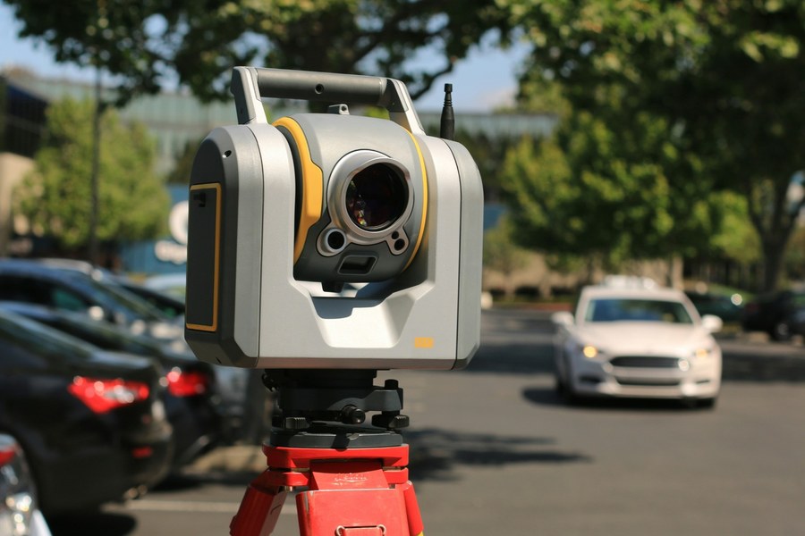 Robotic total station set up on a tripod at a project site
